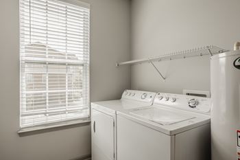 A white washing machine and dryer in a laundry room.